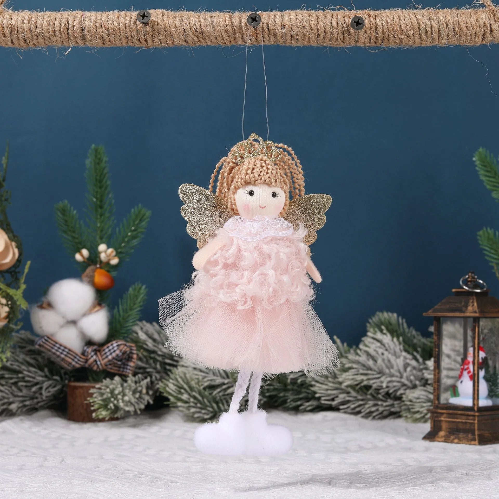 Cartoon angel cloth hair pendant on a girl's high ponytail in white, pink, and khaki colours.