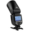 Black DSLR overhead flash with circular lamp head on mini base, with lithium battery and accessories for studio photography