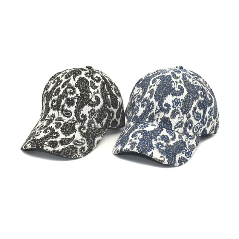 Blue paisley print polyester baseball cap with a dome crown, shown from the side.