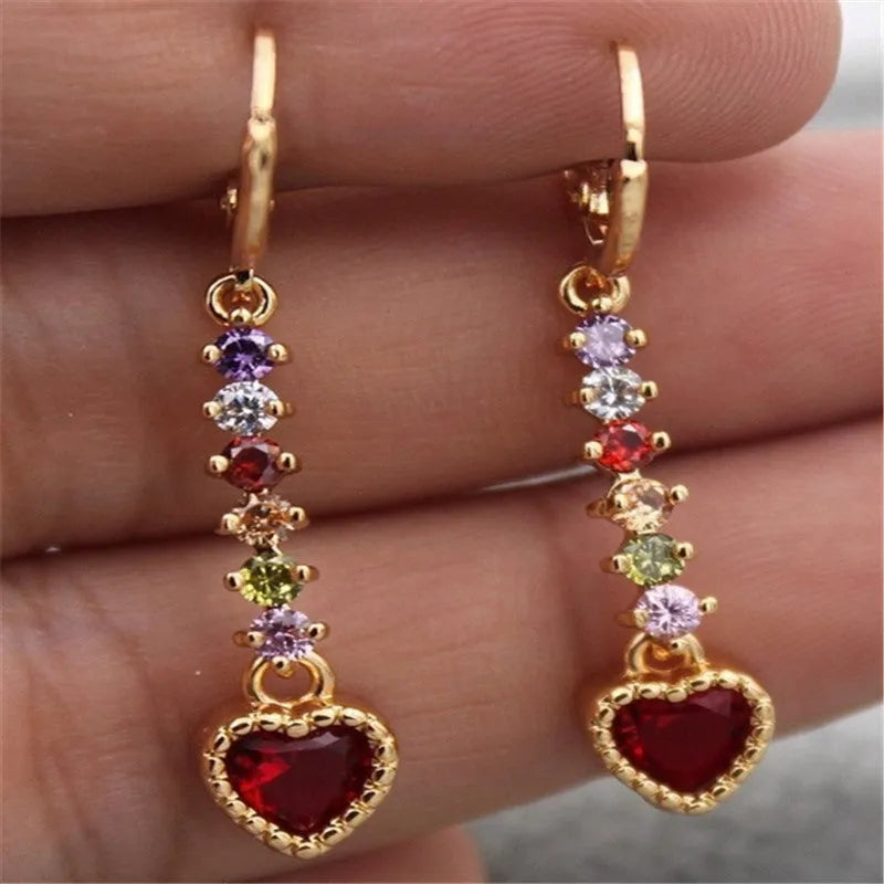 A pair of women's heart-shaped earrings with an electroplated gold or silver finish on an alloy base.
