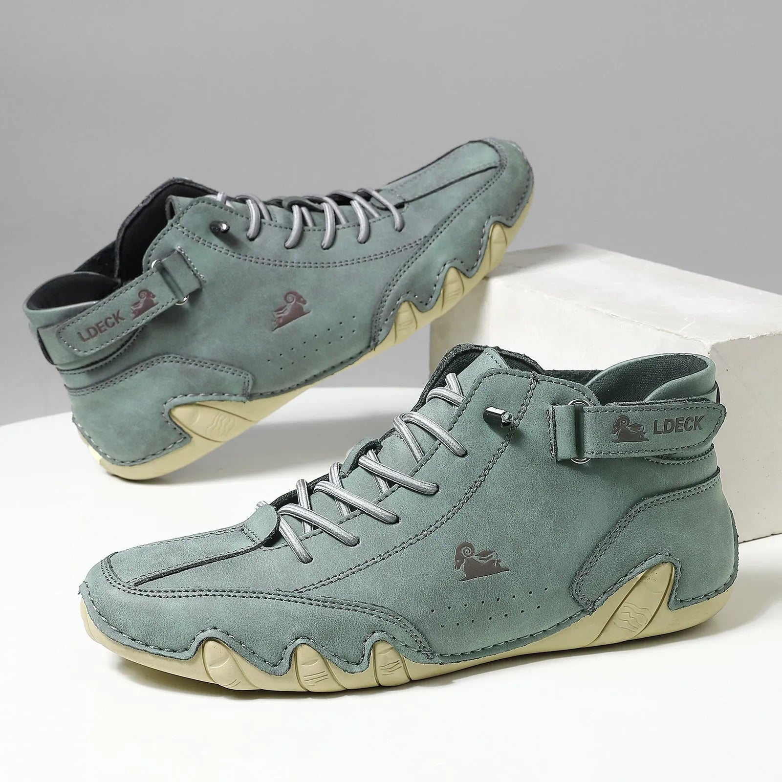 Men's khaki high-top ankle boots with a microfiber upper and rubber sole on a white background.