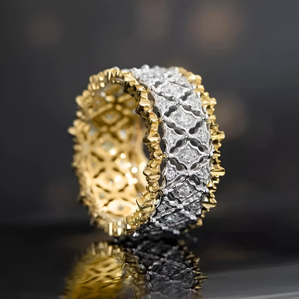 Gold two-tone geometric copper zircon ring on a plain background.