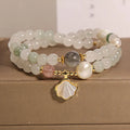 Women's crystal bracelet with Tianshan Jade ginkgo leaf pendant and gold-plated inlay.