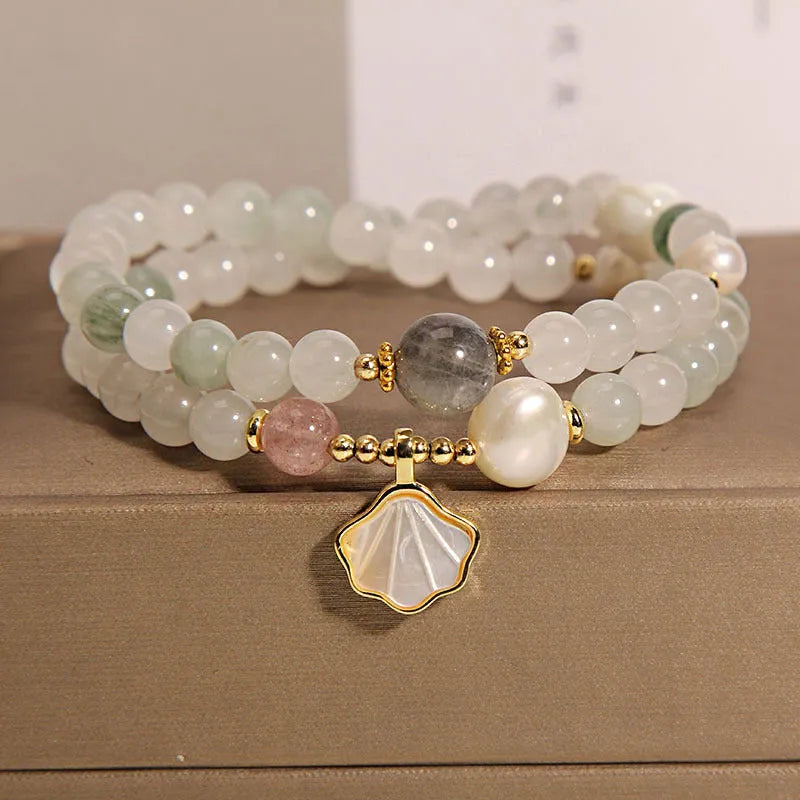 Women's crystal bracelet with Tianshan Jade ginkgo leaf pendant and gold-plated inlay.
