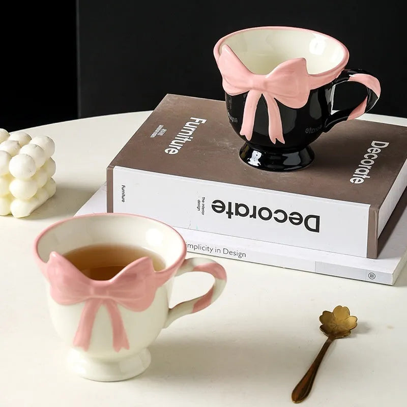 Ceramic mug with heart bow design in white powder and black pink colours.