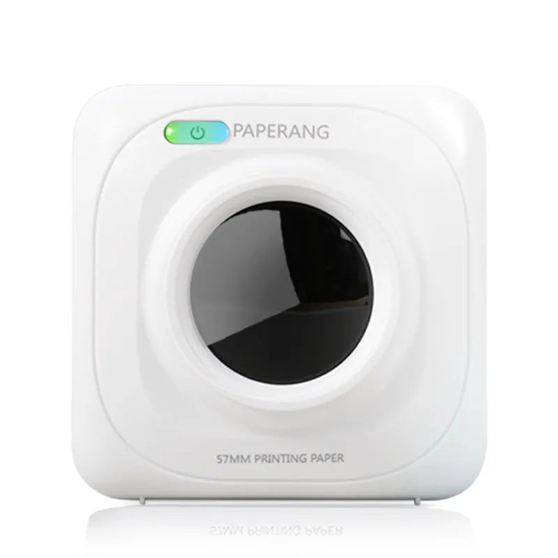 White pocket Bluetooth thermal label printer on desk with smartphone app interface visible