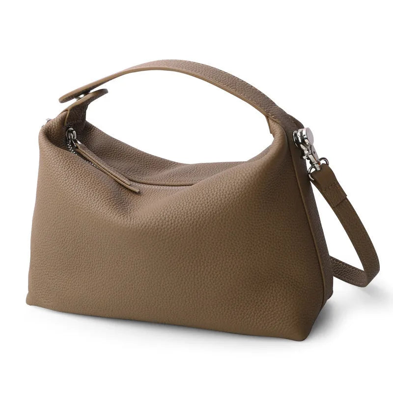 Genuine leather brown one shoulder lunch box bag with zipper closure and multiple internal pockets on white background
