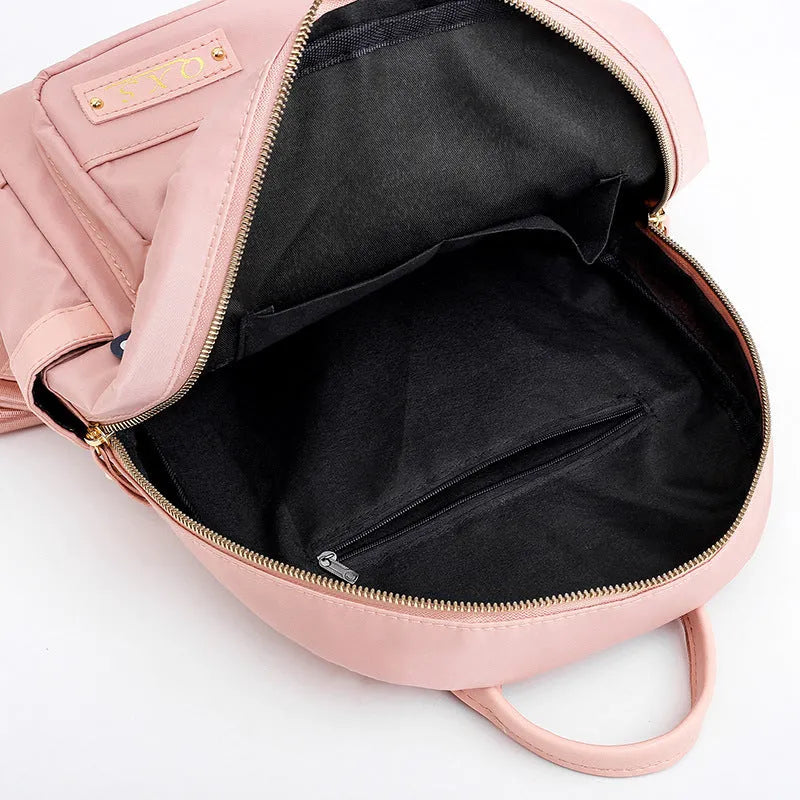 Black square nylon casual backpack with double shoulder straps and a front pocket.