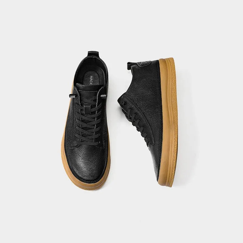 Men's black leather casual trainers with white rubber soles and laces on a white background.