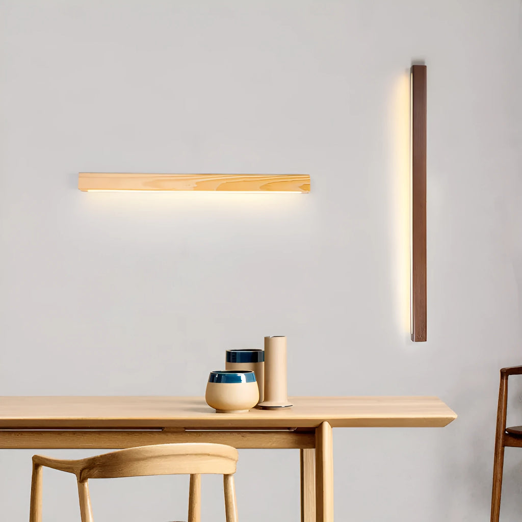 Walnut-coloured minimalist log strip wall lamp mounted on a wall.
