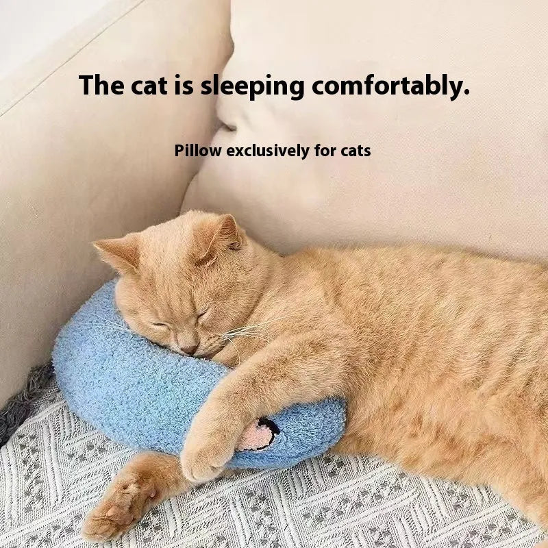 Blue U-shaped cloth pet pillow in a question mark shape on a wooden floor next to a cat carrier.