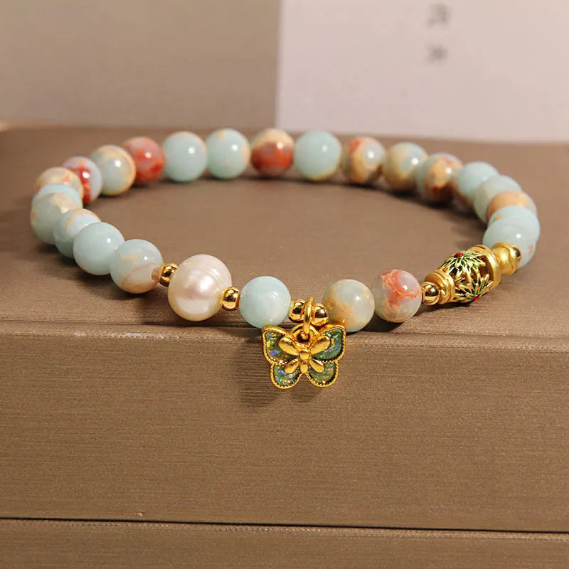 Blue freshwater pearl bracelet with Shoushan stone accents and detailed butterfly pendant