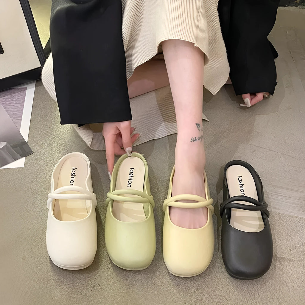 Ladies' plastic summer sandal with toe cap in green, shown from the side.