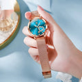 Women's fashion watch with rose shell alloy case and mesh strap, showing one of six available dial colour options.