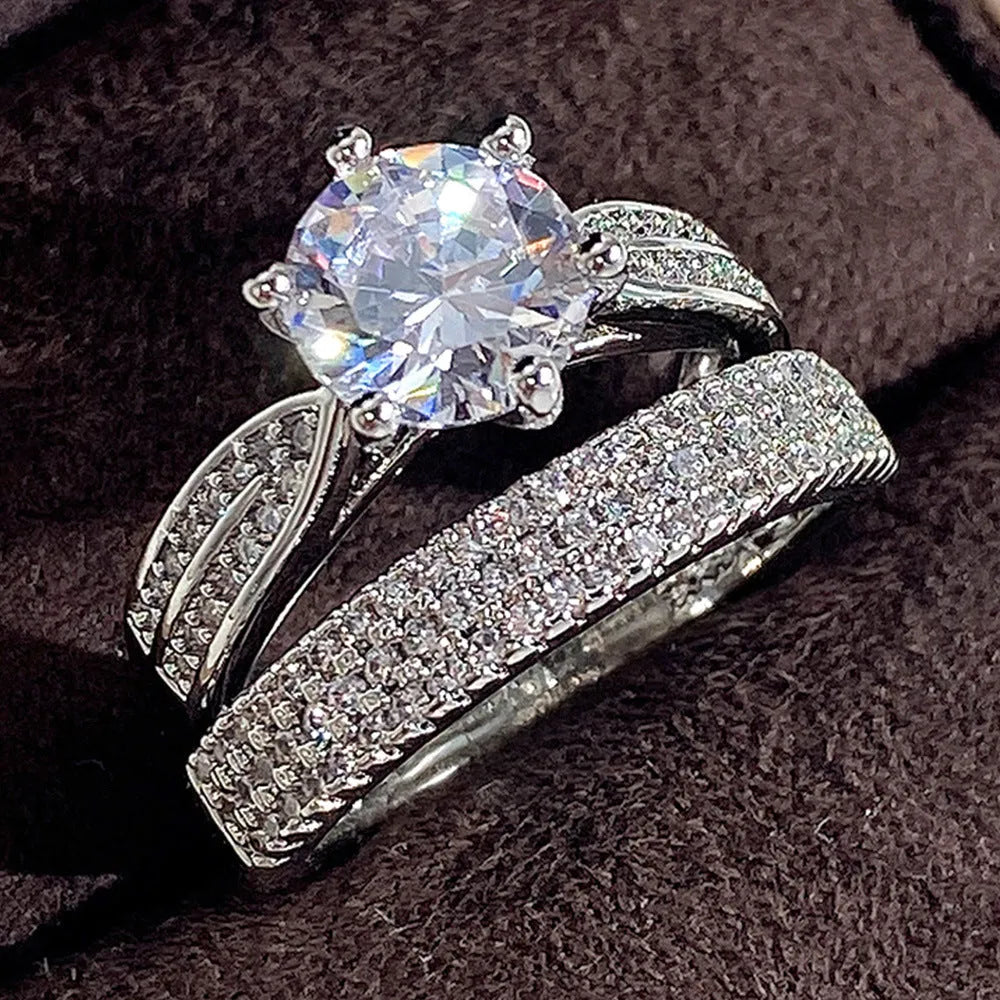 White gold alloy combined ring bracelet with round geometry design on finger.