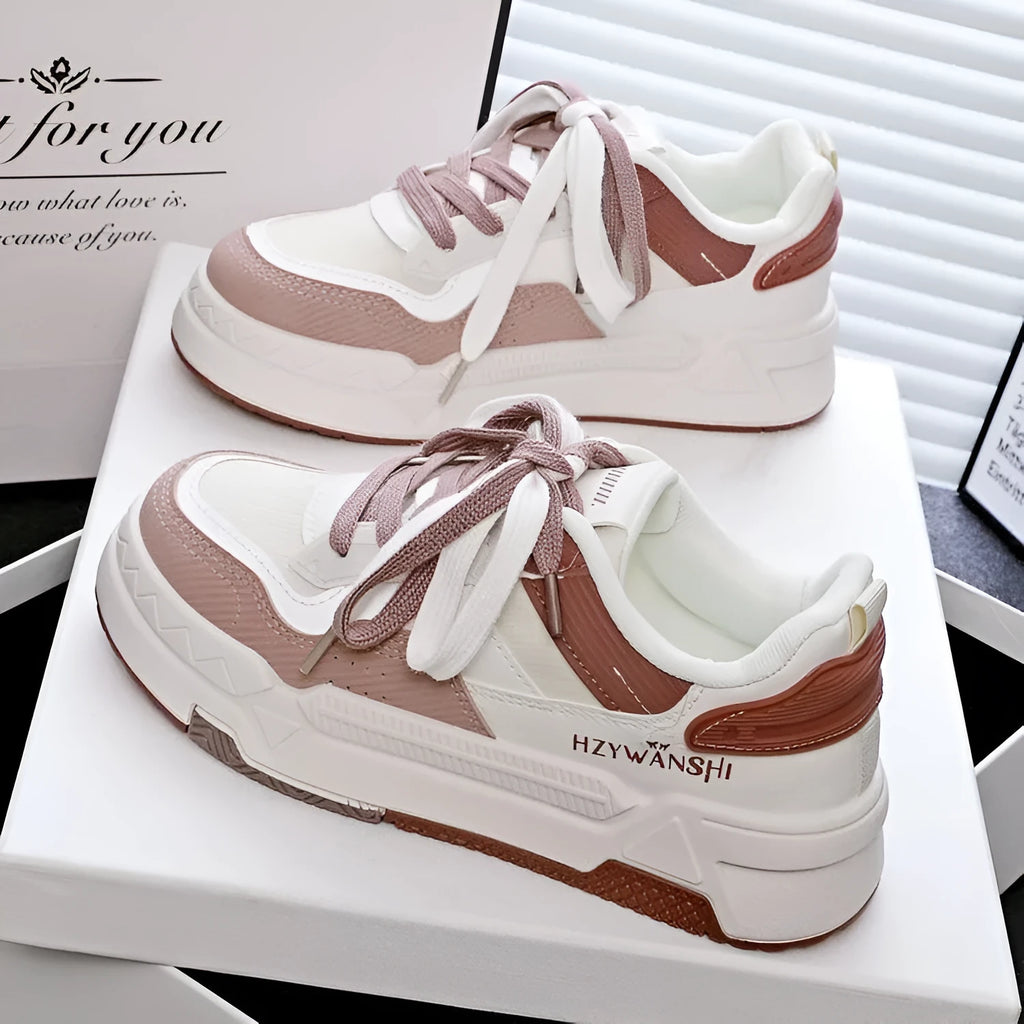 Beige children's lace-up board shoes with cross shoulder straps and a thick rubber sole, shown on a white background.
