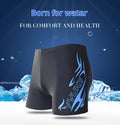 Men's plus size swim trunks with flame pattern and matching swimming cap on a black background.