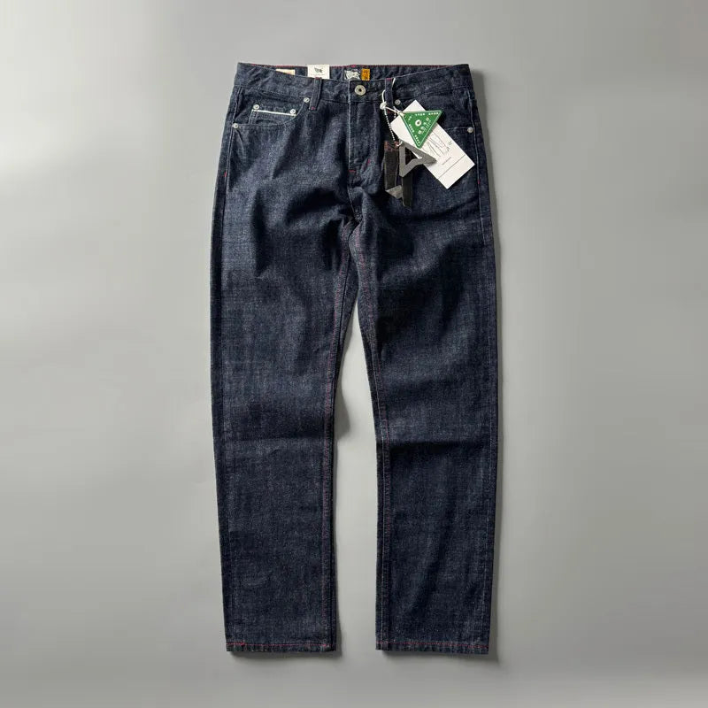 Man wearing blue straight leg denim jeans with a mid waist, showcasing the classic five-pocket retro design.