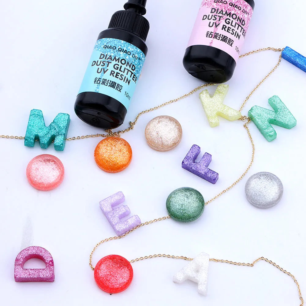 UV epoxy diamond 24 colour set with gold, silver, blue, pink, and green sequins on a white surface