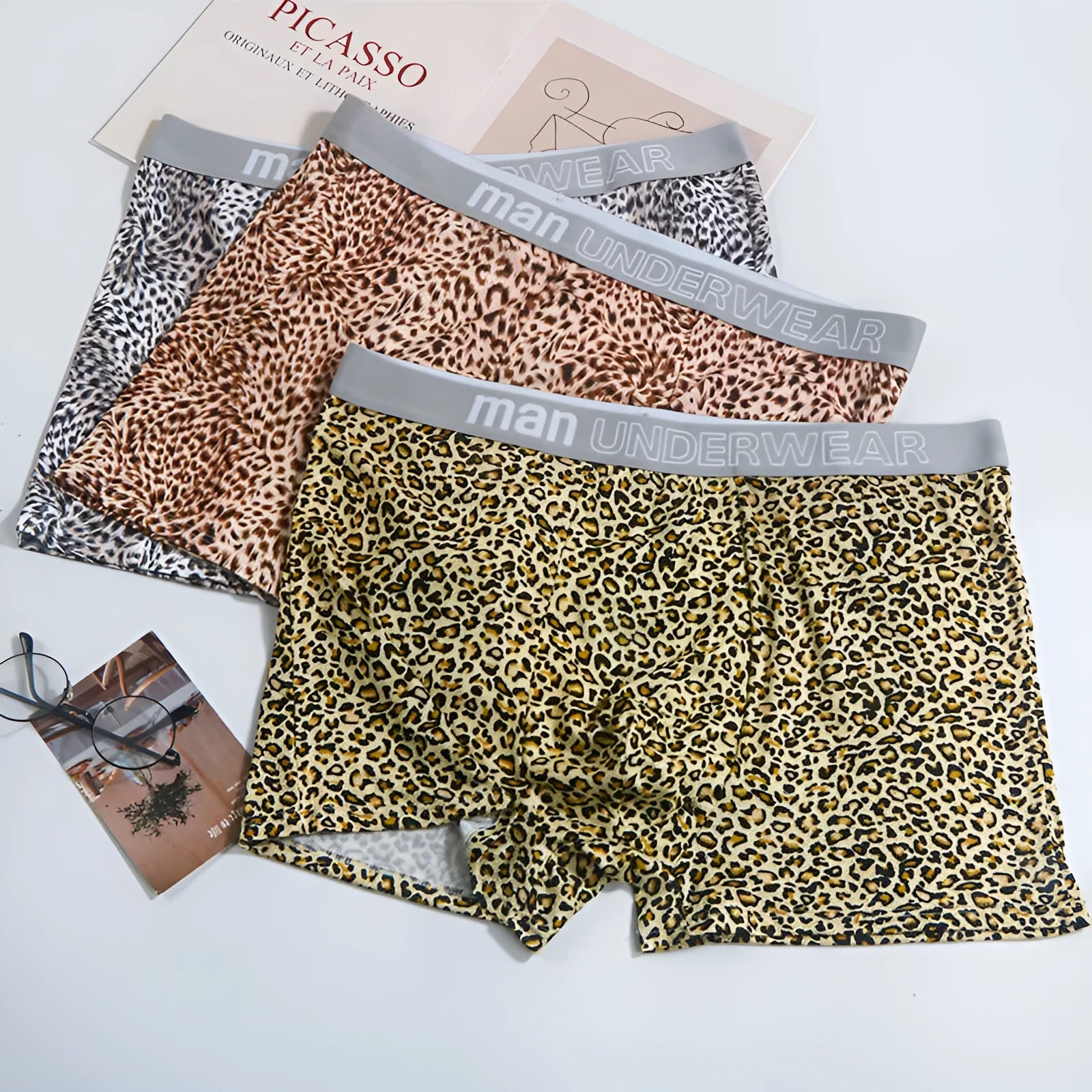 Men's loose fit leopard print underwear in milk silk polyester fabric showing mid-waist design
