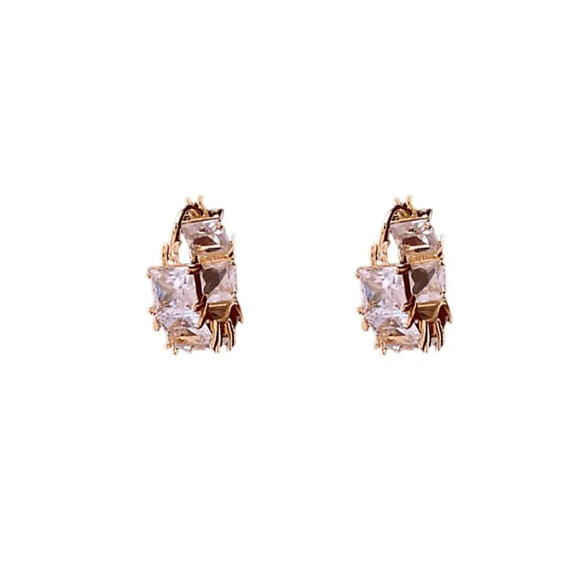 Gold-coloured U-shaped copper earrings with micro-inlaid zircon stones, geometric quadrilateral design, clip-on style.