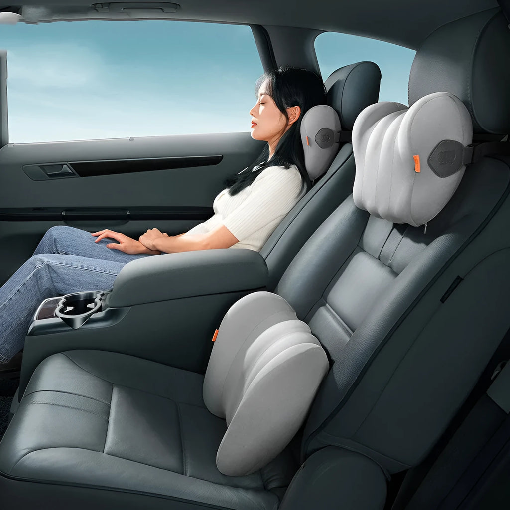 Grey and orange head restraint and lumbar support pillows for car seats.
