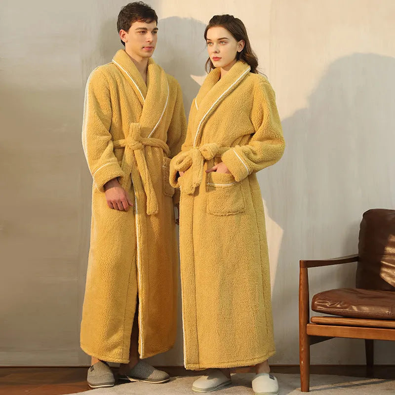 A man and woman wearing matching thick navy blue flannel bathrobes, ankle-length winter nightgown style.