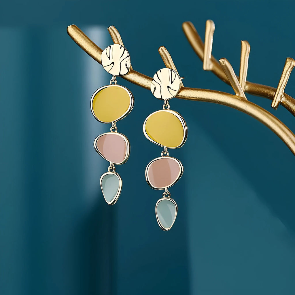 A pair of simple disc-shaped earrings with a blended Morandi colour finish on a sterling silver post.