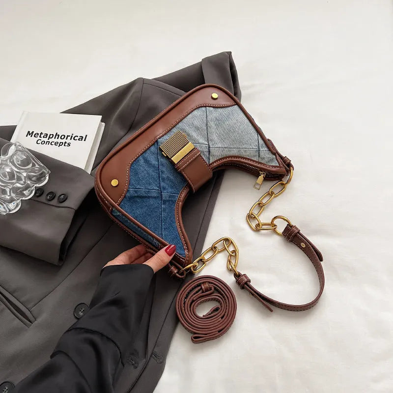 Brown denim women's bucket shoulder bag with diamond mesh detail and a chain strap.