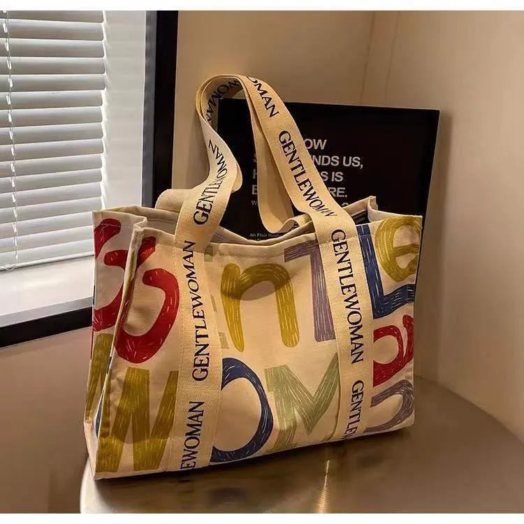 Large canvas women's tote bag with printed design options including letters and patterns