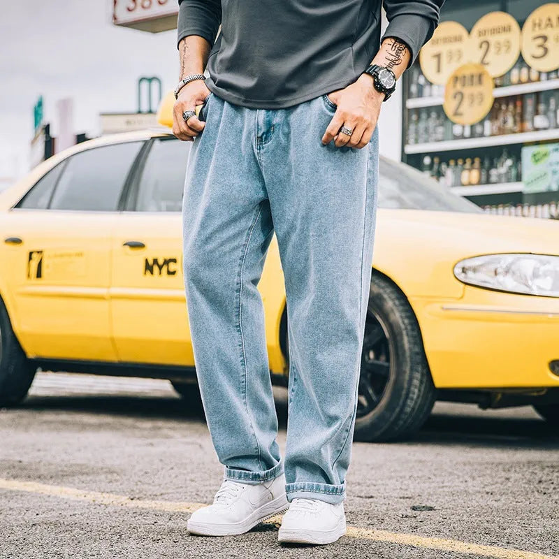 A pair of men's loose-fitting straight-leg casual jeans in dark blue cotton fabric.