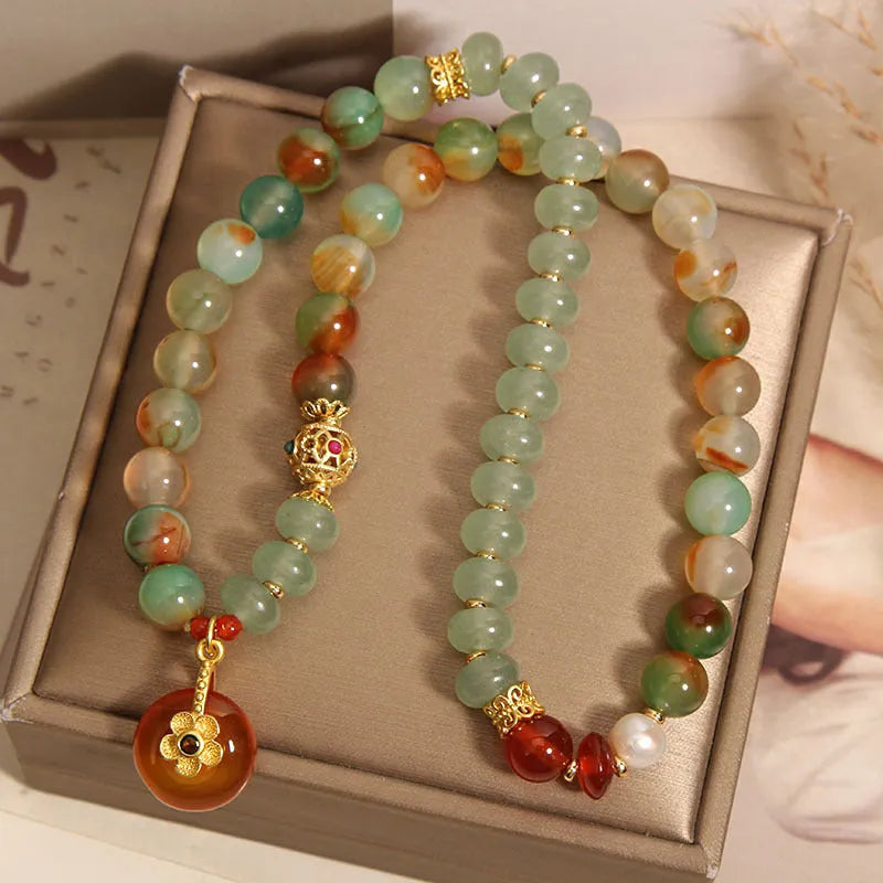Women's peacock green agate double ring bracelet with alloy construction and safety buckle clasp.