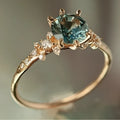 Gold plated geometric claw ring with a set zircon stone and textured square pattern band.