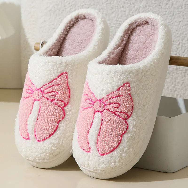 Pink and blue cartoon bow knot oversleeve slippers with suede upper and TPR sole.