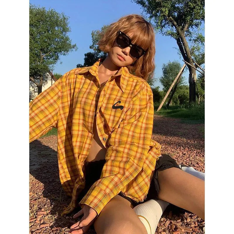 Yellow and white plaid shirt with a loose cardigan fit on a hanger.