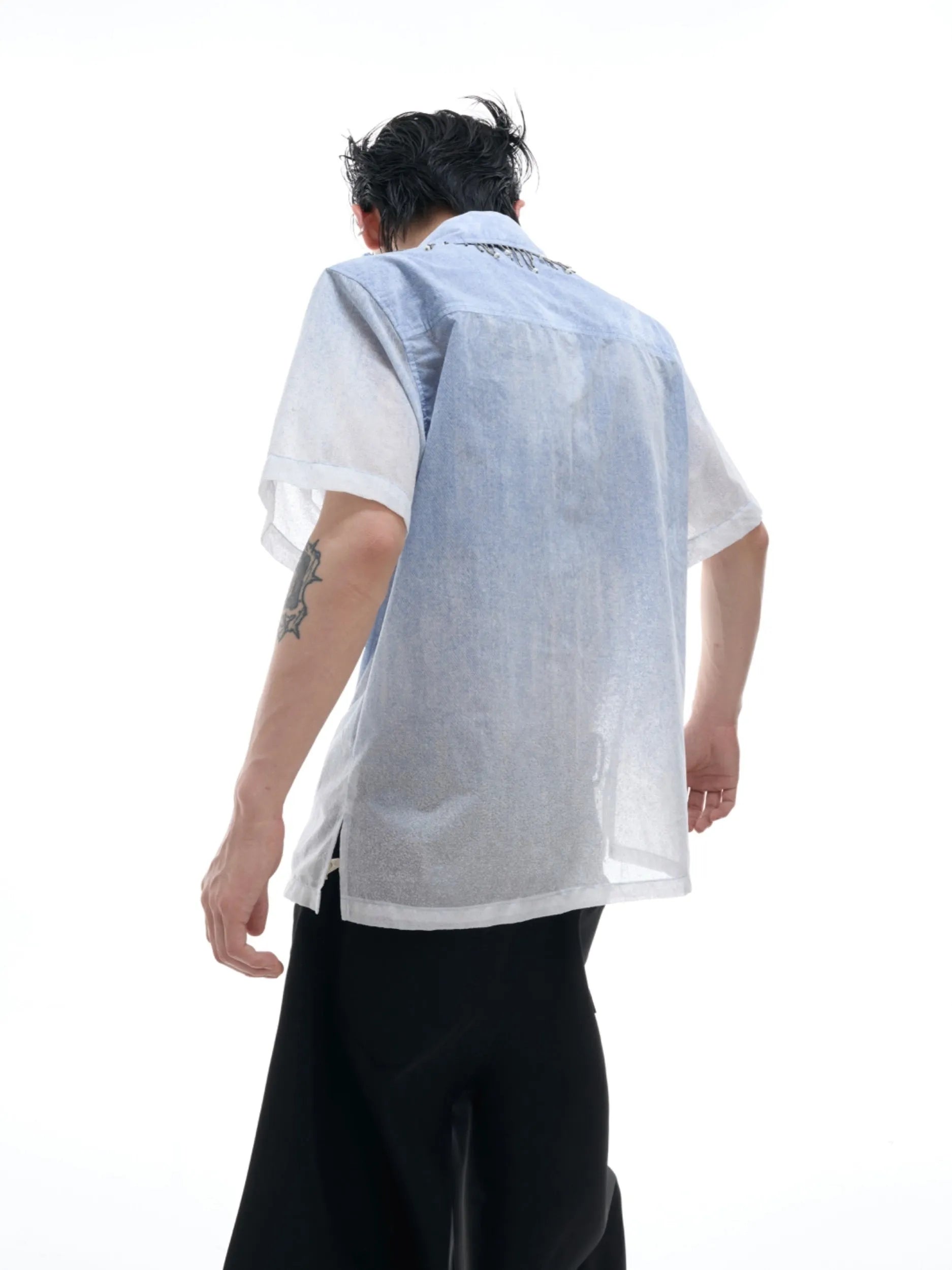 Blue and white gradient short-sleeved loose-fit shirt on a hanger.