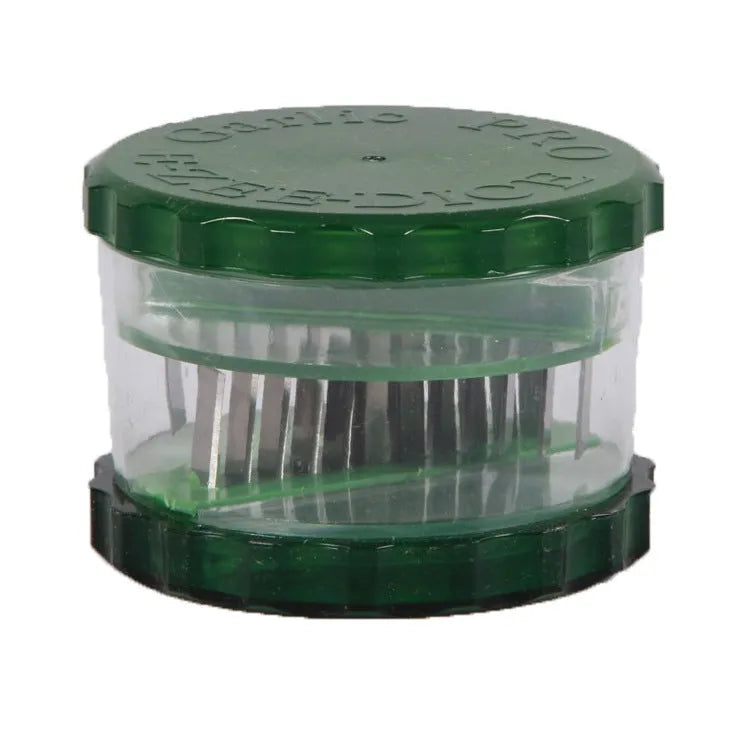 Green transparent plastic garlic peeler kitchen gadget on a counter.