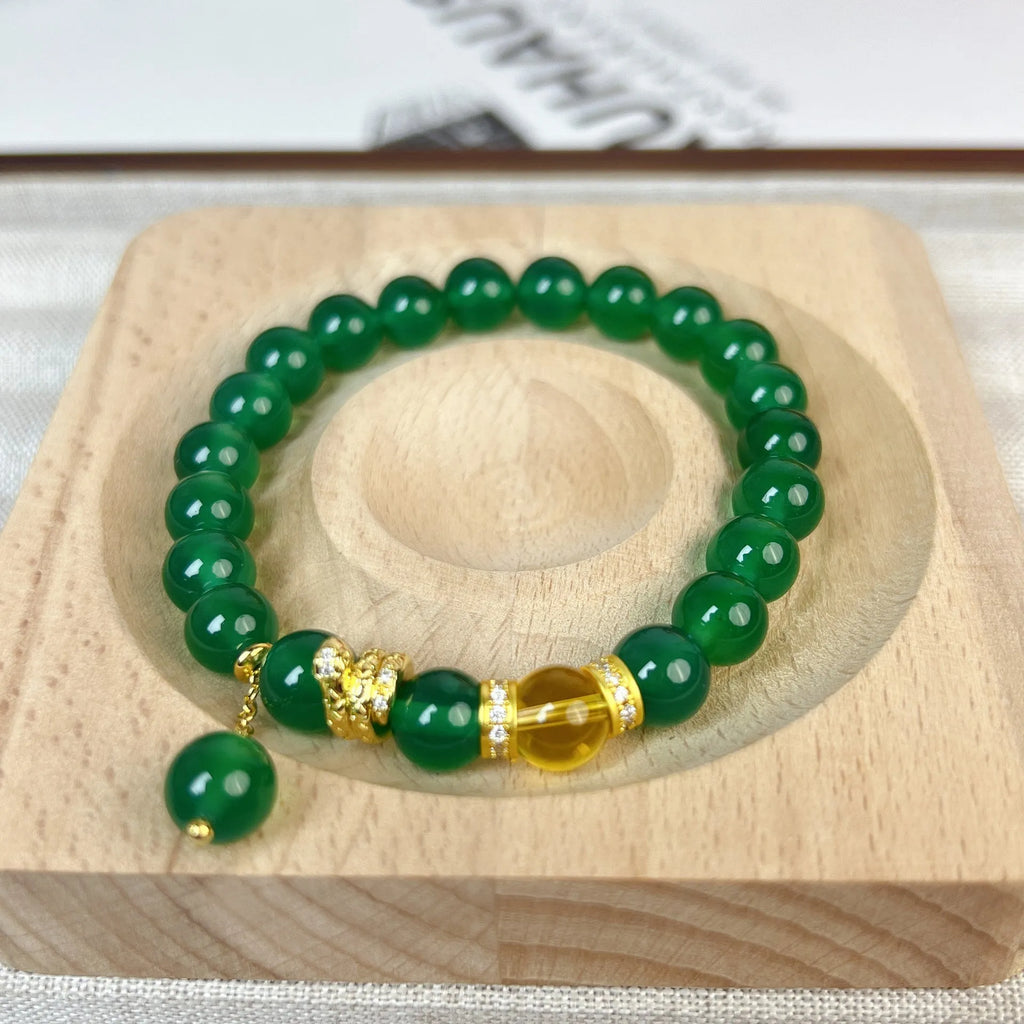 Natural green chalcedony and red agate wealth snake bracelet with copper geometric details.