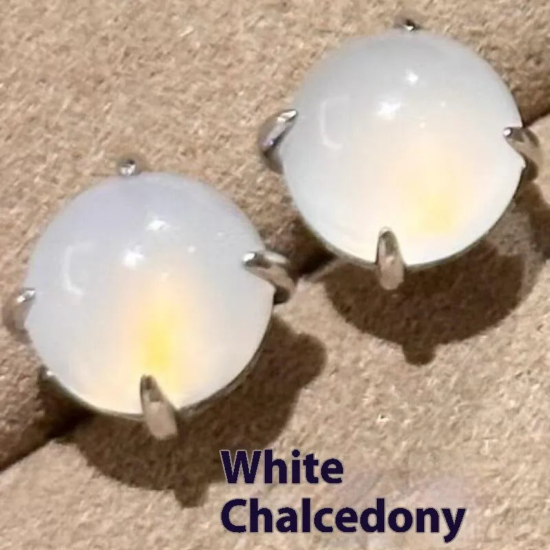 Chalcedony stud earrings with round egg surface design and four-claw settings in copper