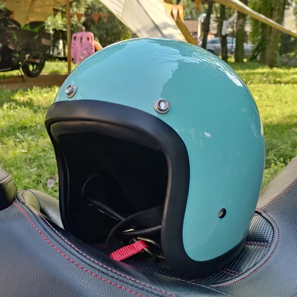 Retro-style open-face motorcycle helmet in cement grey with a textured finish and quick-release chin strap.