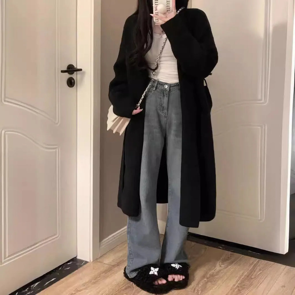 A women's khaki knitted V-neck cardigan with long sleeves, shown hanging to display its mid-length loose fit.