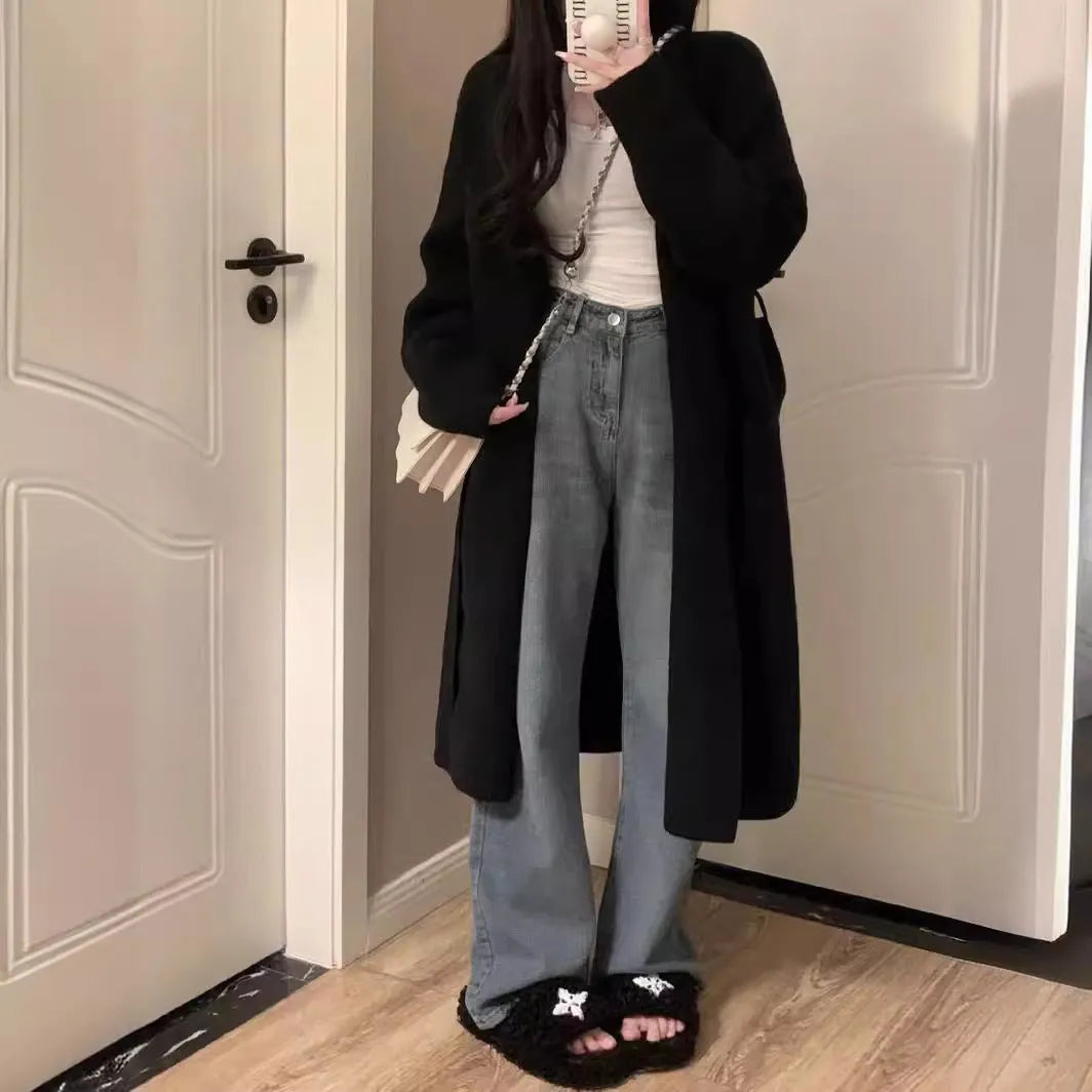 A women's khaki knitted V-neck cardigan with long sleeves, shown hanging to display its mid-length loose fit.