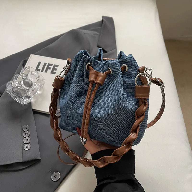 Blue synthetic leather cross body bucket bag with sandwich pocket and one-shoulder strap