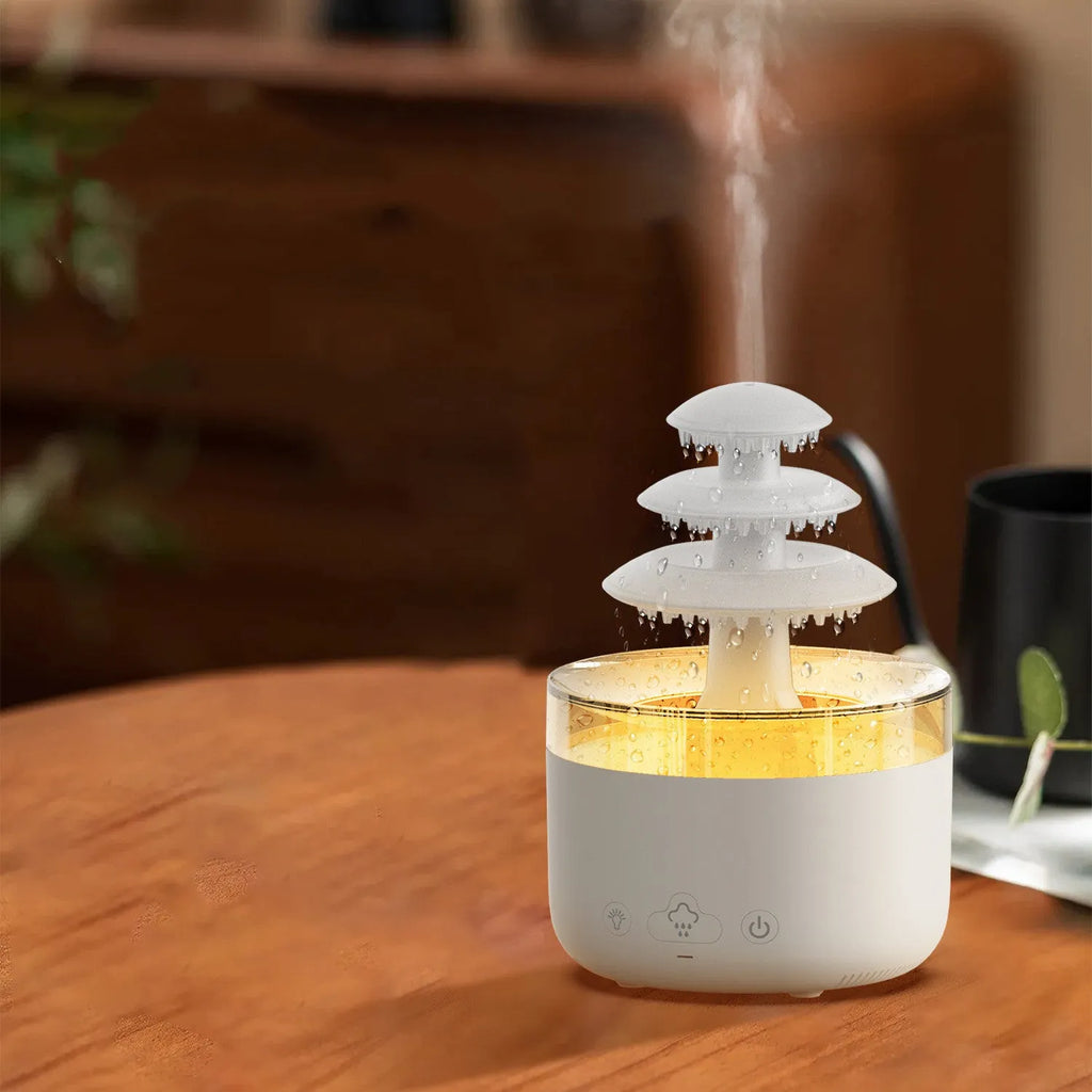 White Cloud Rain ultrasonic humidifier and essential oil diffuser with coloured LED lights on a table.
