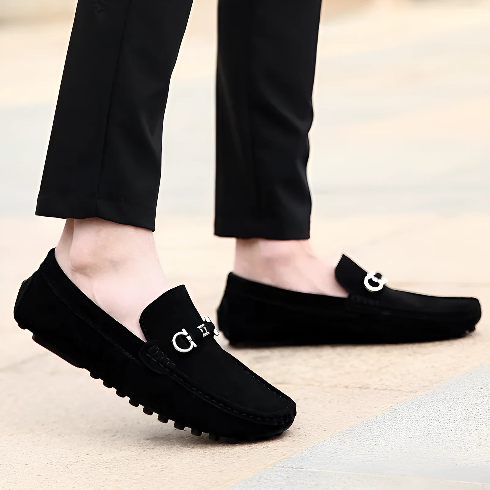 Men's black slip-on leather shoes with square toe and flat rubber sole on a neutral background.