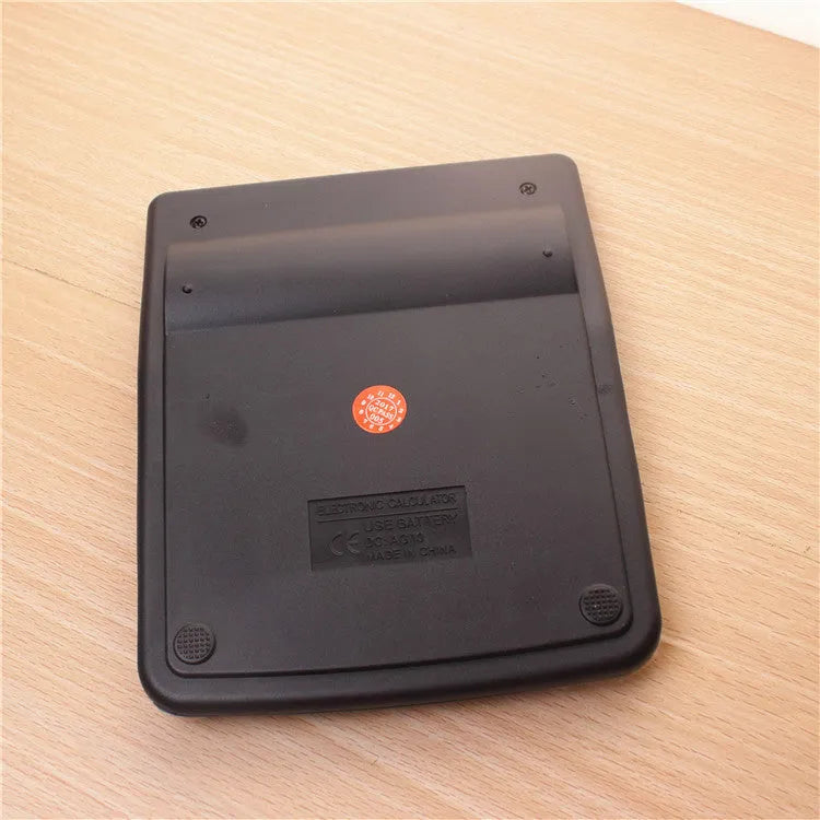 Silver aluminium desktop calculator with compact 14.5x11cm size on desk