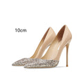 Women's patent leather pointed toe high heels with gold sequin stitching, available in nude or black with thin heel