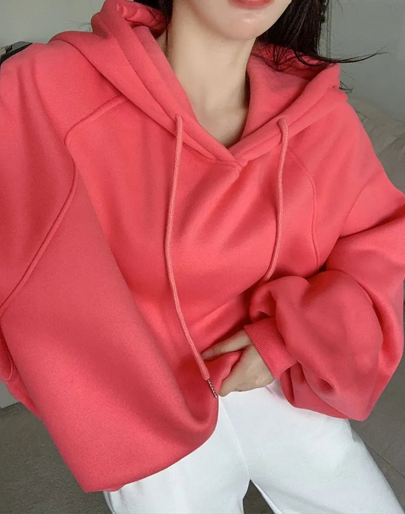 Watermelon red mulberry silk sleeveless hooded sweater for women on a hanger.
