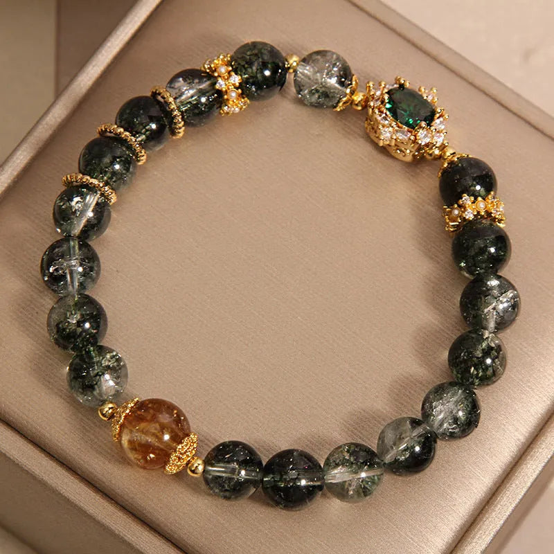 Women's green phantom quartz crystal bracelet with gold rutile needle inclusions and rhinestone accents
