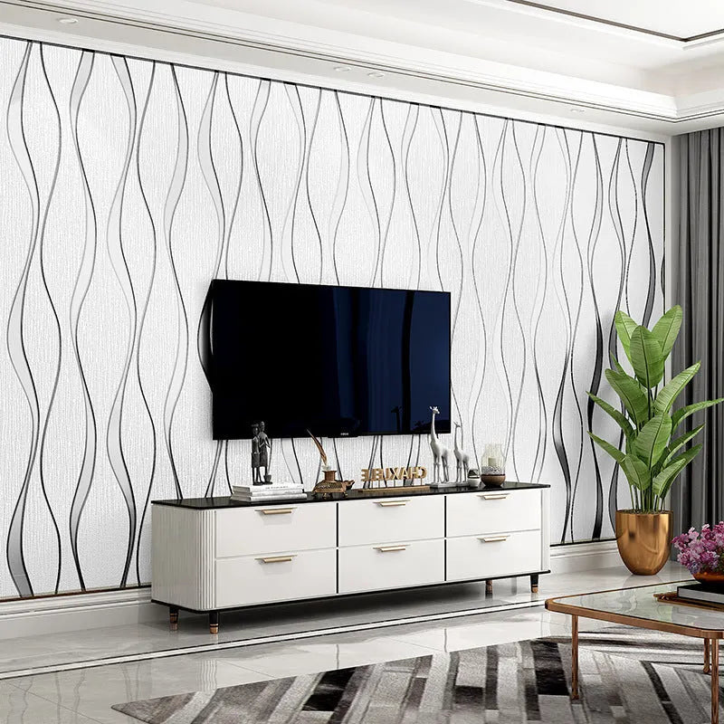 Roll of grey 3D stripe wallpaper with thick velvet texture next to a sample on a wall